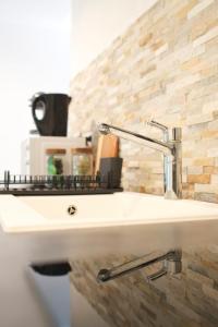 - Baño con lavabo y pared de ladrillo en L'atypique des choux, en Les Choux