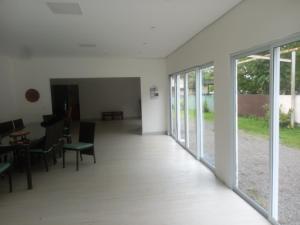 an empty room with sliding doors and a table and chairs at camping sonho traga seu in São Sebastião