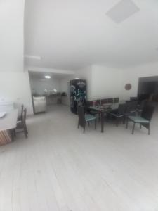 an empty room with chairs and tables in a room at camping sonho traga seu in São Sebastião