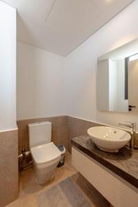 a bathroom with a white toilet and a sink at Lumina -1 BR Chalet in Kamaran, Gouna in Hurghada +11 photos