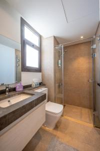a bathroom with a toilet and a sink and a shower at Lumina -1 BR Chalet in Kamaran, Gouna in Hurghada