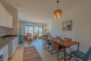 a kitchen and living room with a table and chairs at Lumina -1 BR Chalet in Kamaran, Gouna in Hurghada