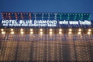a sign on the side of a building with lights at Hotel BLUE DIAMOND in Begusarai