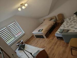 a small attic bedroom with a bed and a window at Dom Weselny Izabela Noclegi in Osiek