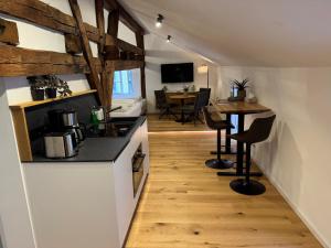 a kitchen with a counter and a table in a room at Altstadt Apartments 27 in Beilngries