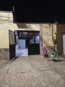 a group of chairs sitting outside of a building at Aluguel de quarto por diária in São Luís