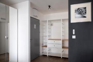 a room with white cabinets and a glass door at Skyline Flat near City Center by Richies in Bratislava