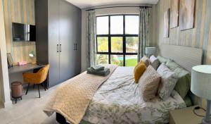 a bedroom with a large bed and a window at Table View Escape in Cape Town