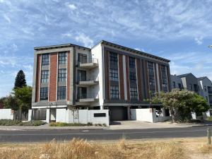 a large building with a lot of windows at Table View Escape in Cape Town