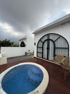 a house with a large swimming pool on a wooden deck at Lagoluxe in Gretek