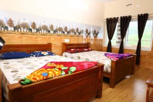 a bedroom with two beds and a window at HAPPY NEST home stay valparai in Vālpārai +5 photos