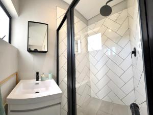 a bathroom with a sink and a shower at Table View Escape in Cape Town +9 photos