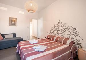 a bedroom with a large bed with towels on it at Norma House on the Rocks in Norma