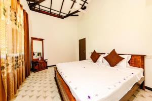 Ένα ή περισσότερα κρεβάτια σε δωμάτιο στο Ocean Hill Ahungalla +2 φωτογραφίες