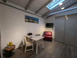 a room with a table and a red chair at Ferienhaus mit großer Terasse in Kellenhusen