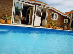 a swimming pool in front of a house at La case d'Isabelle in Saint-Denis