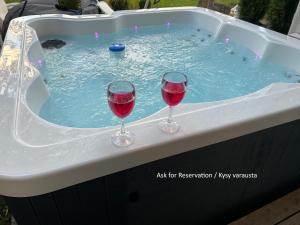 two glasses of wine sitting in a hot tub at BySannah in Porvoo