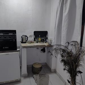 a kitchen with a table with a laptop on it at Hospedaje El Colibri in Ezeiza