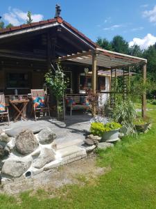 a pavilion with a table and chairs in a garden at Ferienhaus Haigrub in Perasdorf