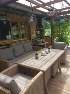 a patio with a wooden table and chairs at Ferienhaus Haigrub in Perasdorf +6 photos