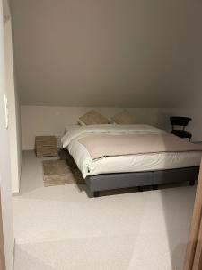 a bedroom with a bed and a night stand at De Kempische Hoef in Westerlo