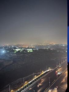 a highway lit up at night with street lights at The Triple-Bedroom Escape in Rawalpindi