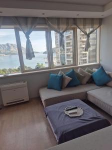 a living room with a couch and a large window at FONTANA FRONT of SEA APARTMENT in Budva