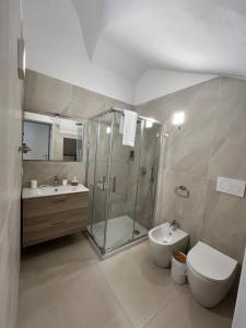 a bathroom with a shower and a toilet and a sink at Kalsa’s House Noto in Noto +31 photos