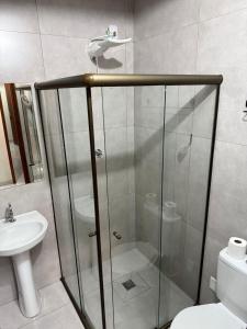 a bathroom with a shower and a toilet and a sink at Royal Hotel in Dourados +11 photos