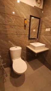 a bathroom with a toilet and a sink at Hotel Premium in Chandīgarh +1 photo