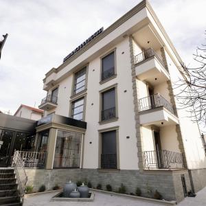 a building with balconies on the side of it at Comfort Rezidence In Hotel in Tirana