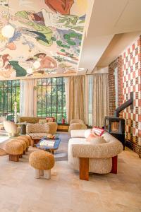a living room with couches and a painting on the ceiling at Verneuil la douce in Verneuil d’Avre et d’Iton