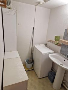 a small bathroom with a sink and a toilet at T2 familial climatisé mer à pied parking privé in Saint Cyprien Plage