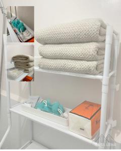 a white shelf with towels and a box on it at Casa Lena - Bulacan Staycation in Marilao