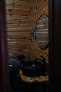 a bathroom with a black sink and a mirror at Sunny Side - მზიანი მხარე in K'eda +54 photos