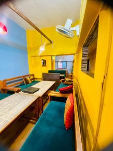 a living room with a table and a couch at Hotel MAQ Lumbini in Lumbini