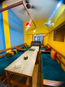 a room with several tables and a couch at Hotel MAQ Lumbini in Lumbini