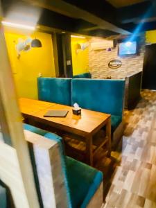 a table and some blue chairs in a restaurant at Hotel MAQ Lumbini in Lumbini