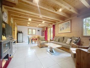 a living room with a couch and a table at Chalet en bois avec très belle vue sur la montagne in Colmars
