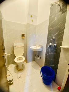 a bathroom with a toilet and a sink at Hotel MAQ Lumbini in Lumbini