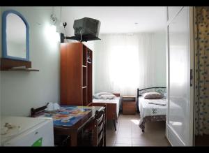 a room with a kitchen with a table and a bed at Золотий Якор in Gribovka