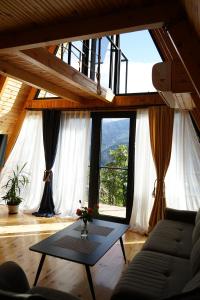 a living room with a couch and a table at Sunny Side - მზიანი მხარე in K'eda