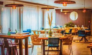 a dining room with wooden tables and chairs at Camping Del Mar 64, Mobile Home Premium, 2 chambres, 4 personnes, 1 Salles de Bain, bord de mer in Argelès-sur-Mer