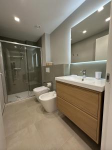 a bathroom with a sink and a toilet and a shower at IsabellaGuestHouse in Chiusa di Pesio