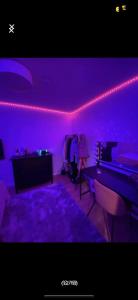 a purple room with a ping pong table and a purple light at Guesthouse Platina centrum in Oslo