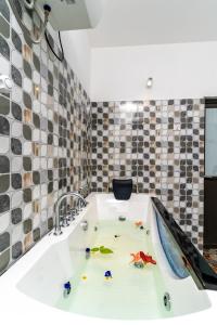 a bathroom with a tub with toys in it at Olhumathi View Inn in Ukulhas +193 photos