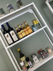 a shelf with bottles of wine and other items at IsabellaGuestHouse in Chiusa di Pesio