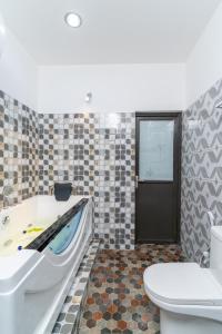 a bathroom with a tub and a toilet and a sink at Olhumathi View Inn in Ukulhas