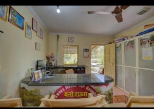 a kitchen with a counter and chairs in a room at Yellow House in Zirad