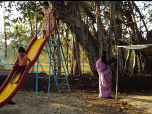 two girls playing on a slide at a playground at Yellow House in Zirad